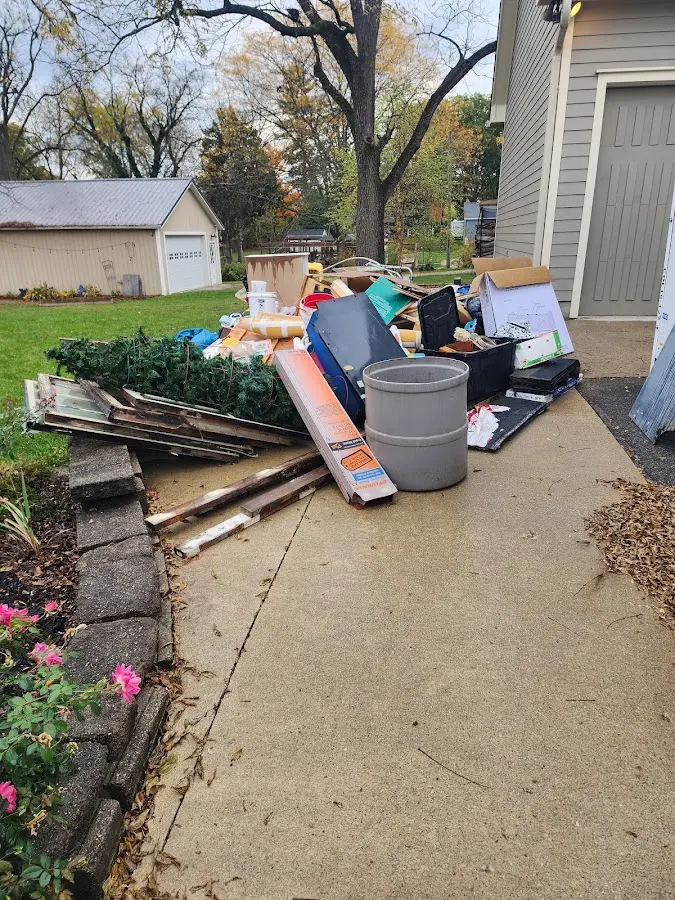 Dumpster being loaded with debris for Estate Cleanout Dumpster Rental in Huntington Woods